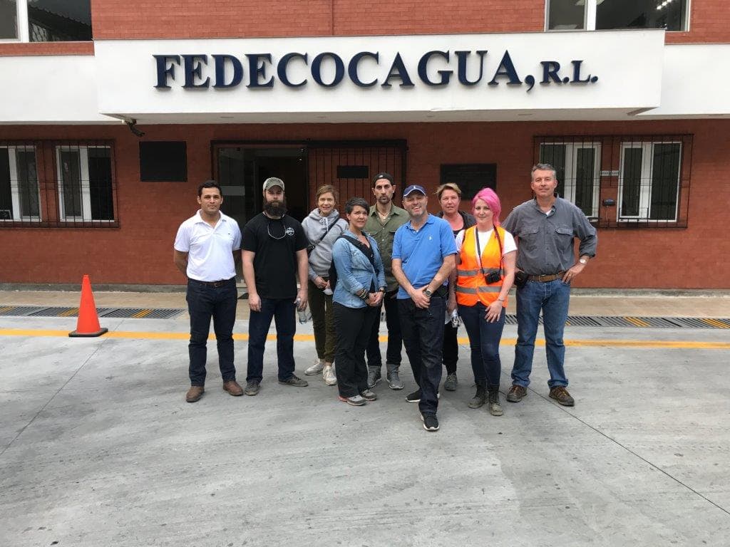 Group photo in front of the FEDECOCAGUA cooperative building